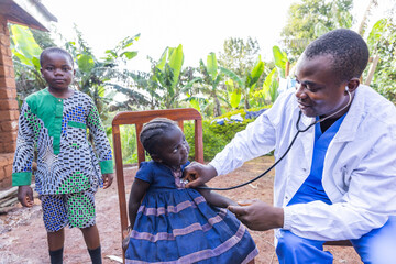 A pediatrician uses a stethoscope during a visit to children in a village in Africa