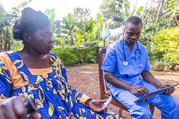 A doctor consults the prescription on his tablet and delivers drugs to his elderly patient in Africa