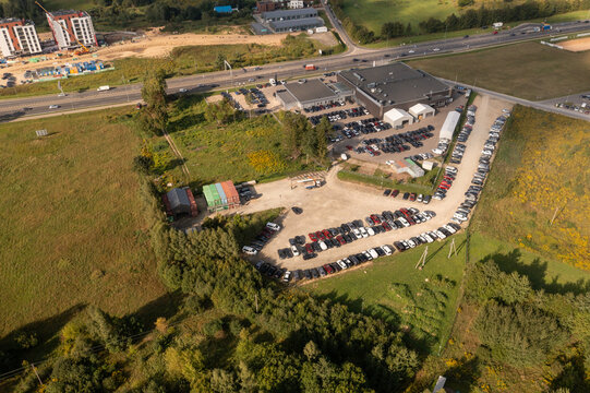 Drone photography of logistical warehouse, car parks and highway road