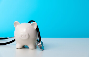 Piggy bank with stethoscope on the table