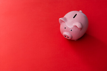 Piggy bank on red background