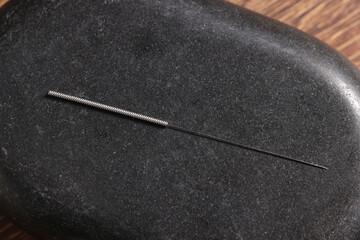 Stone coaster with acupuncture needle, top view