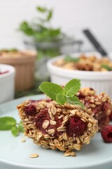 Tasty baked oatmeal with raspberries on table, closeup