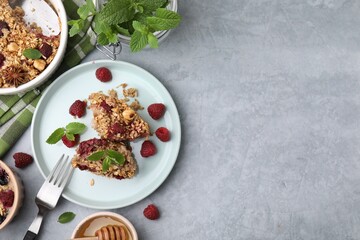 Tasty baked oatmeal with berries served on light grey table, flat lay. Space for text