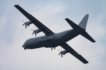 Untitled military transport plane at air base. Airport and airfield. Air force and army flight operation. Aviation and aircraft. Air lift. Military industry. Fly and flying.