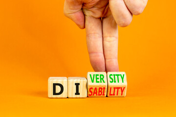 DEI Diversity or disability symbol. Concept words Diversity disability on wooden block. Beautiful orange table orange background. Businessman hand. Business diversity disability concept. Copy space.