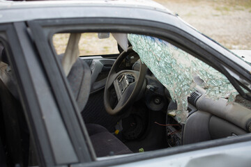 abandoned car with broken windscreen