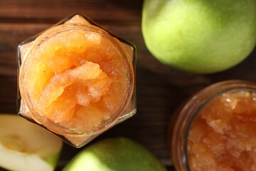 Delicious apple jam and fresh fruits on wooden, flat lay