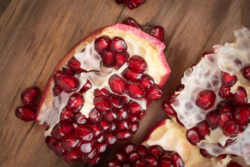 Fresh, ripe pomegranate on a wooden background.