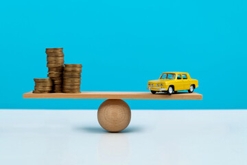 Seesaw with coins and car model