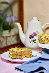 walnut dacquoise cake or Kiev cake with meringue layers and vanilla buttercream with coffee near window