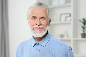 Portrait of handsome senior man at home