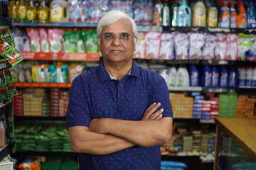 Portrait of Happy and smiling Indian old age man purchasing in a grocery store. Confident and fit Grandpa buying grocery for home in a supermarket.