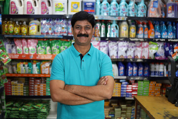 Portrait of Happy and smiling Indian man purchasing in a grocery store. Buying grocery for home in a supermarket. Confident and fit man in moustache.
