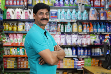 Portrait of Happy and smiling Indian man purchasing in a grocery store. Buying grocery for home in a supermarket. Confident and fit man in moustache.