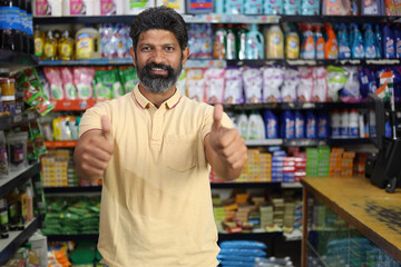 Beautiful portrait of handsome and smiling bearded man shopping and posing in hypermarket. Local mini mall happy smiles of satisfied customer.