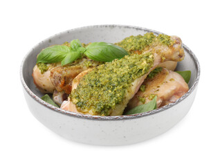 Delicious fried chicken drumsticks with pesto sauce and basil in bowl isolated on white