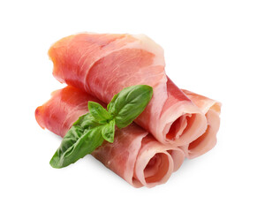 Rolled slices of delicious jamon and basil leaves isolated on white