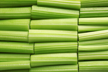 Fresh green cut celery as background, top view