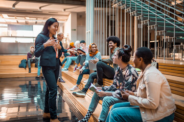 Young and diverse group of students having a conversation in the university lobby