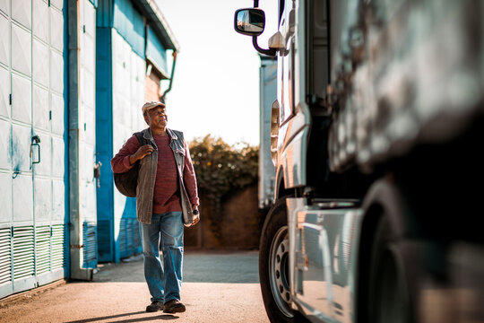 Senior truck driver walking to his vehicle to go on the road