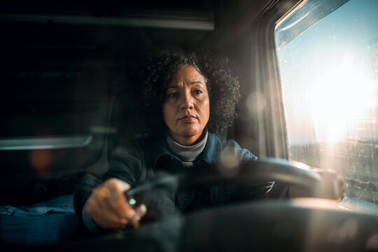 Middle aged female truck driver on the road