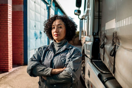 Portrait of a confident young female truck driver in front of her vehicle