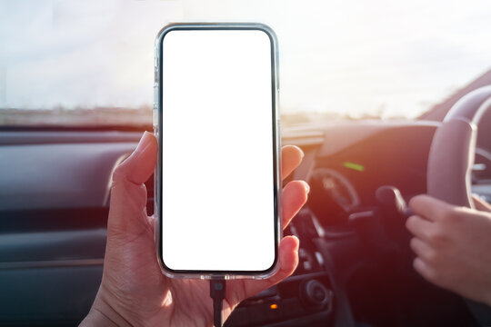 Man holding Smartphone in car with blank screen for entering text or pictures.