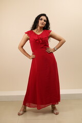 Fototapeta premium Lady flaunting. Beautiful portrait of a confident, sexy young lady in red gown flaunting and wearing eyewear.