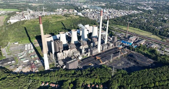 Aerial drone view of a large fossil fuels hard coal power plant in Germany. Generation of energy by burning fossil fuels.