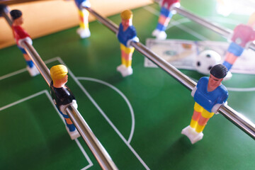 Table football game with US dollar bills scattered around it, alluding to a betting concept