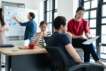 Group of young creative multiethnic business team brain storm meeting presentation,discussing roadmap to product launch, planning,strategy,new business development,working with new startup project in
