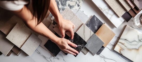 Interior designer and customer selecting marble stone color for kitchen or facades with the client seeking advice from the decorator With copyspace for text - obrazy, fototapety, plakaty