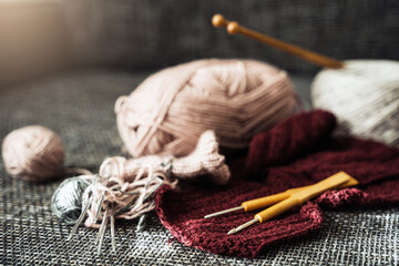 Woolen threads, knitting needles and crochet hooks - obrazy, fototapety, plakaty