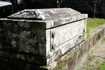 A stone tomb in an outdoor area.