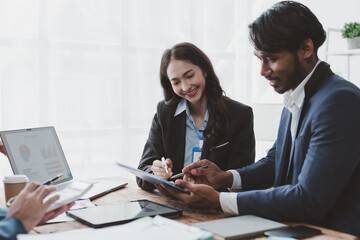 Group of young Asian business people talk, consult, discuss working with new startup project idea presentation analyze plan marketing and investment.