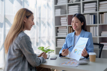 Two Asian business women are talking and consulting.