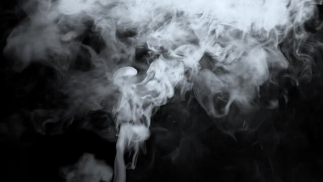 Abstract white smoke in slow motion. white smoke on a black background . 4k ice smoke cloud. green screen . Floating fog.