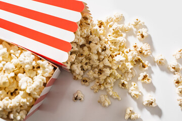 Classic striped buckets with delicious popcorn on white background