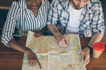 Couple planning future travel on map