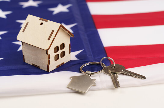 USA flag and key from home as symbol of VA loan on the desk
