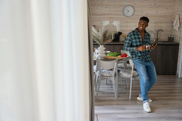 Nice guy communicates online on his mobile phone