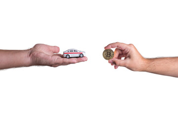 Car and bitcoin in hand on a white background. Buying a new car with Bitcoin.
BTC purchasing opportunity.
