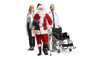 Injured santa claus with a foot brace and arm sling standing with a male and female doctors with a...