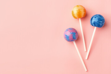 Tasty lollipops on pink background, flat lay. Space for text