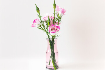 eustoma bouquet in a pink glass vase on a white background. Generative AI
