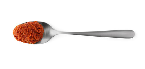 Tasty curry paste in spoon isolated on white, top view