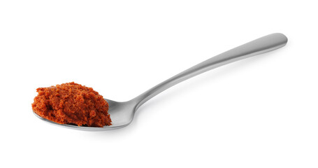 Tasty curry paste in spoon isolated on white
