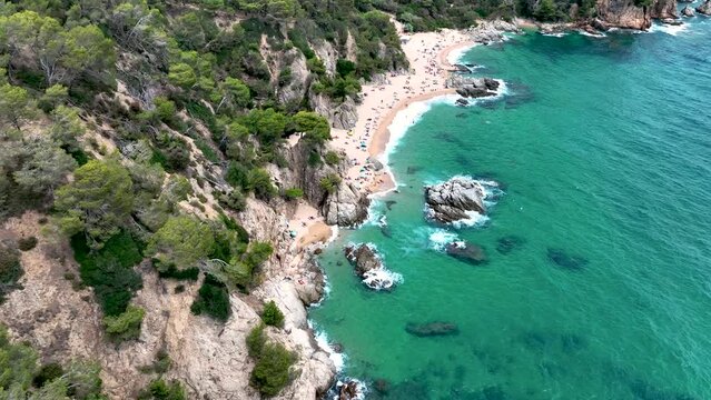Cala sa Boadella beach in the resort town of Lloret de Mar, Spain. View from a drone, from above.