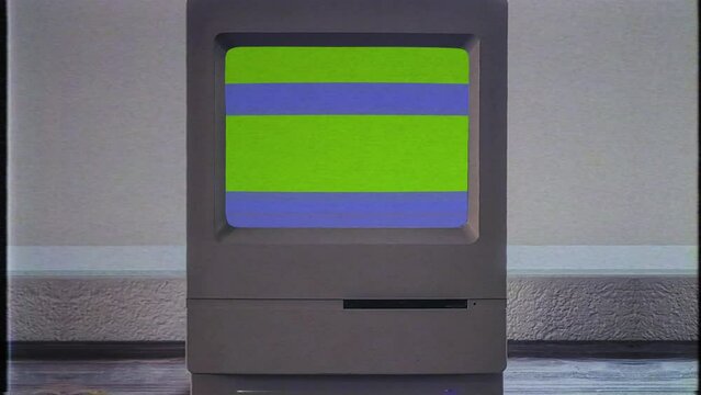 Retro Computer Green Screen Glitch Vintage PC Desktop. Vintage desktop computer with green screen glitch, for replacement, inside of a house.